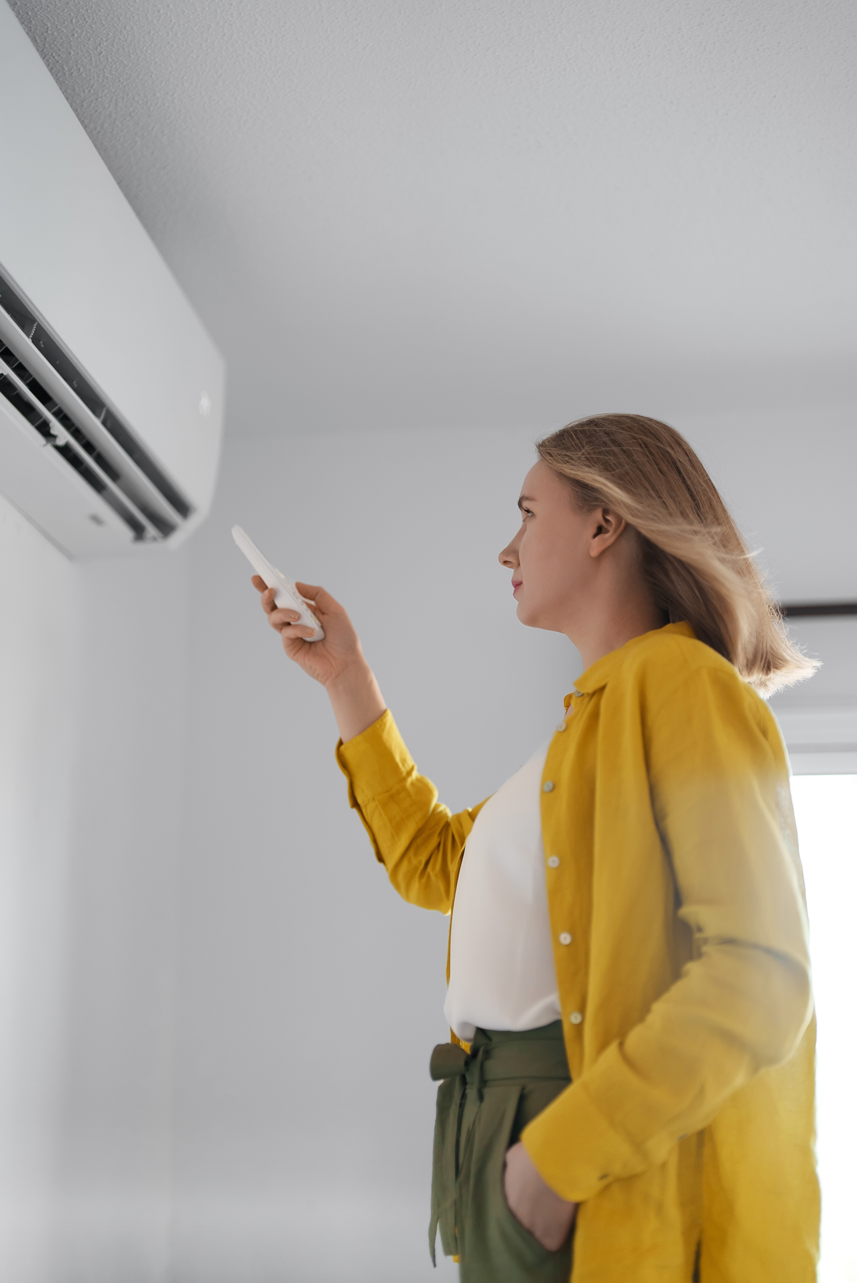 A homeowner struggling with common hvac problems - contact Ultimate Air Inc today!